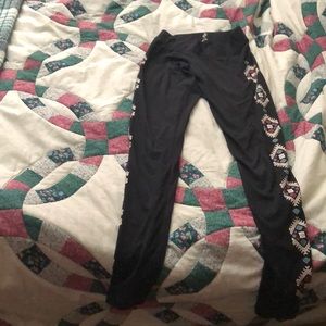 Black leggings with a pink,blue and white aztec print on the side